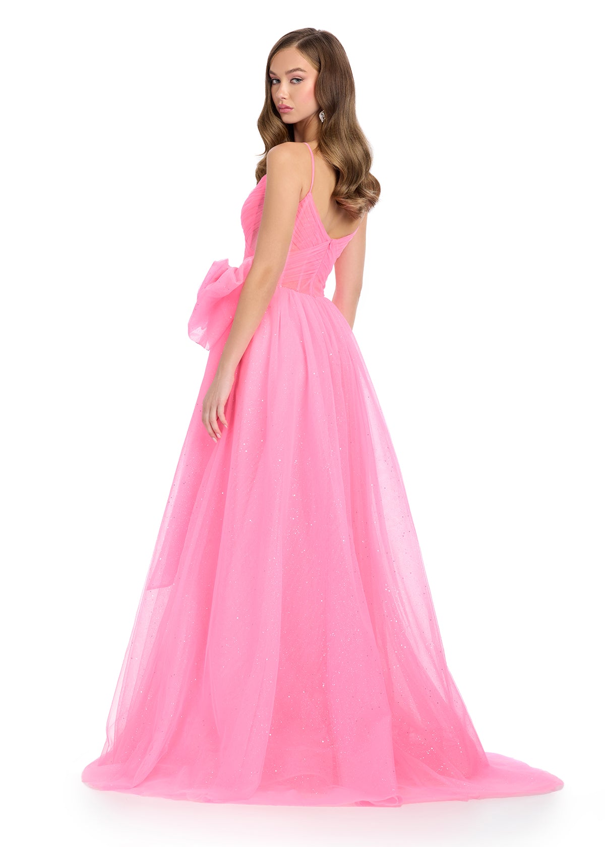 Back - Sparkle all night in this enchanting tulle gown featuring a sweetheart neckline, delicate spaghetti straps, and a statement bow accent for a touch of elegance. Perfect for special occasions.