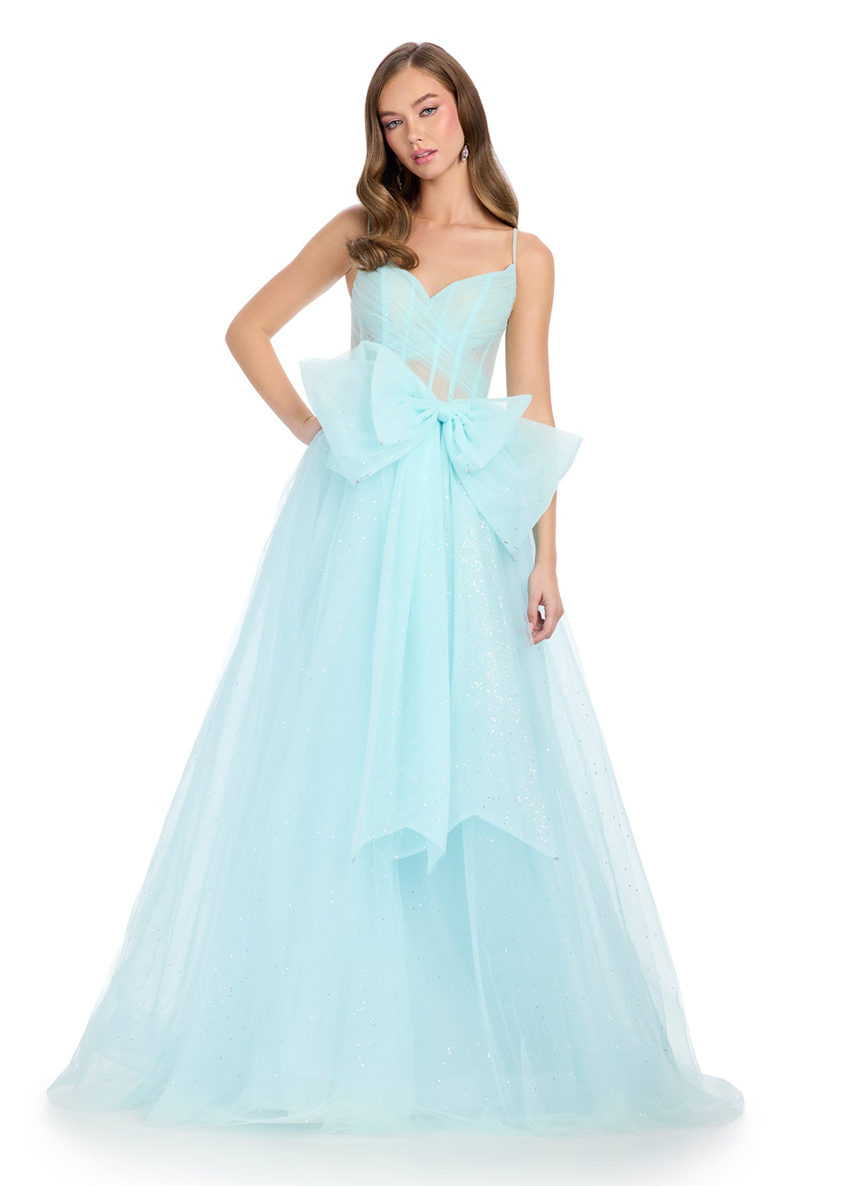 Sparkle all night in this enchanting tulle gown featuring a sweetheart neckline, delicate spaghetti straps, and a statement bow accent for a touch of elegance. Perfect for special occasions.