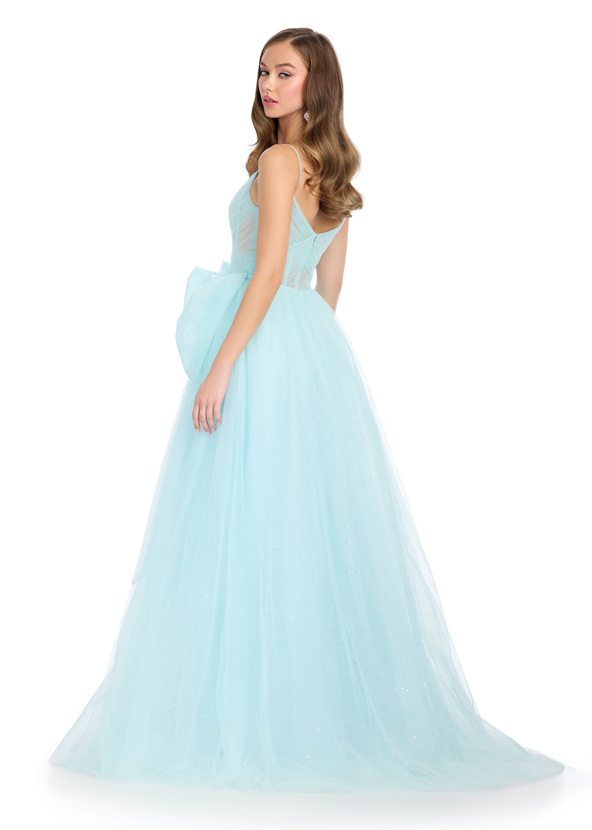 Back - Sparkle all night in this enchanting tulle gown featuring a sweetheart neckline, delicate spaghetti straps, and a statement bow accent for a touch of elegance. Perfect for special occasions.