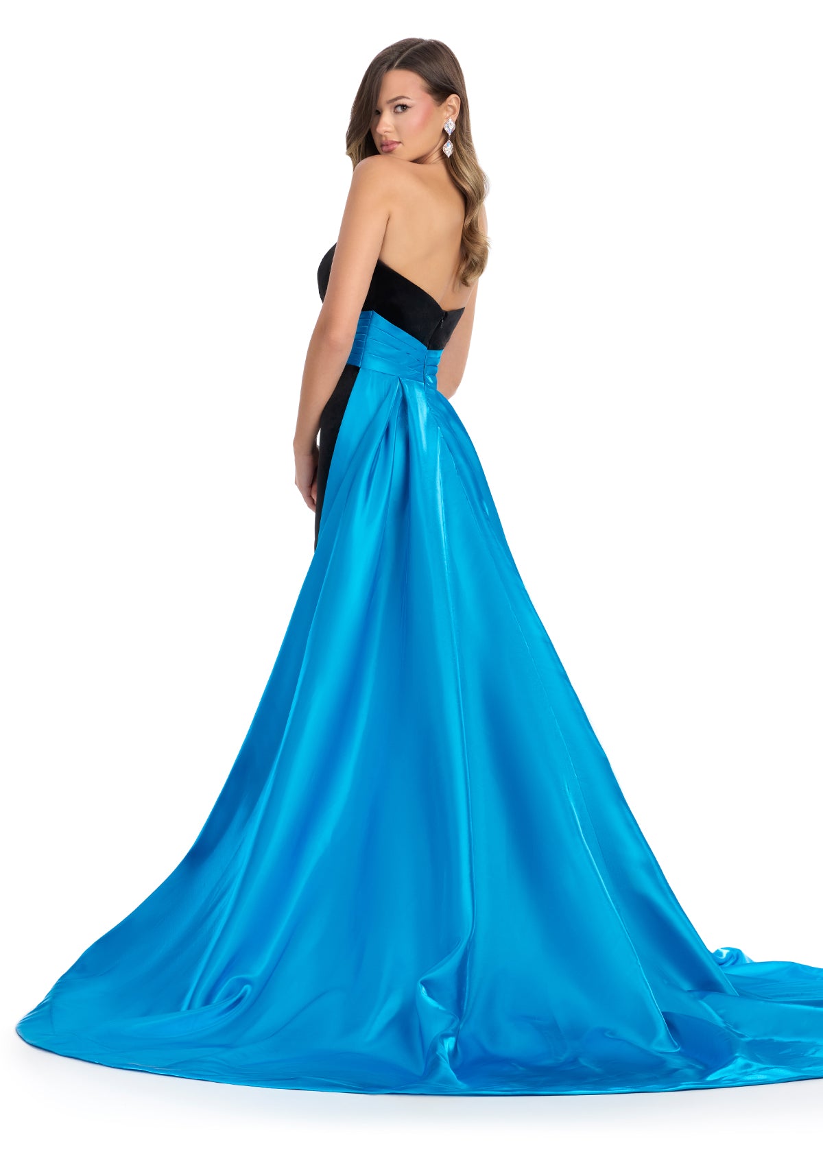 Back - Classic and elegant strapless velvet gown featuring a figure-flattering satin overskirt that cinches the waist, paired with a left leg slit for a sophisticated and timeless look. Perfect for special occasions.