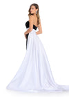 Back - Classic and elegant strapless velvet gown featuring a figure-flattering satin overskirt that cinches the waist, paired with a left leg slit for a sophisticated and timeless look. Perfect for special occasions.