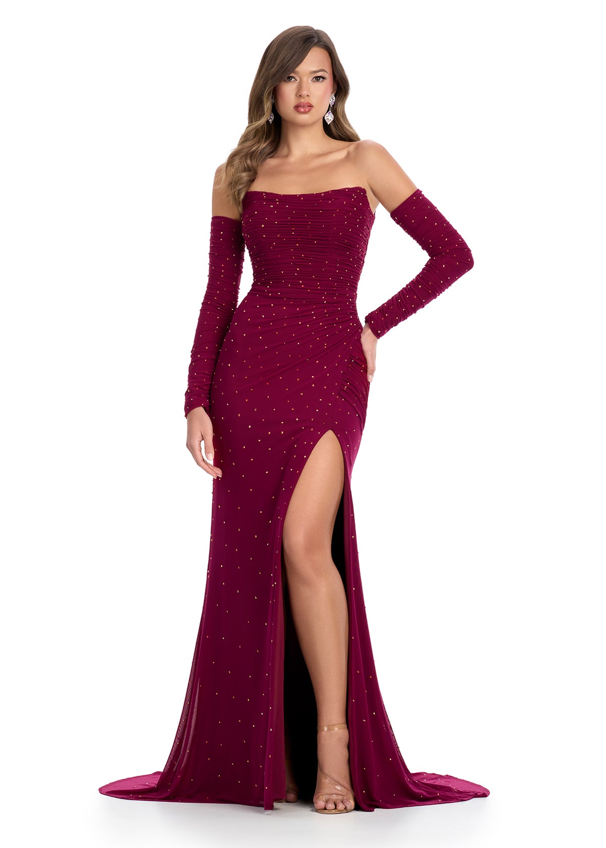 Dazzling strapless gown featuring shimmering press-on stone embellishments, detachable sleeves for added elegance, a left leg slit, and a sweep train for a glamorous finish. Perfect for special occasions.