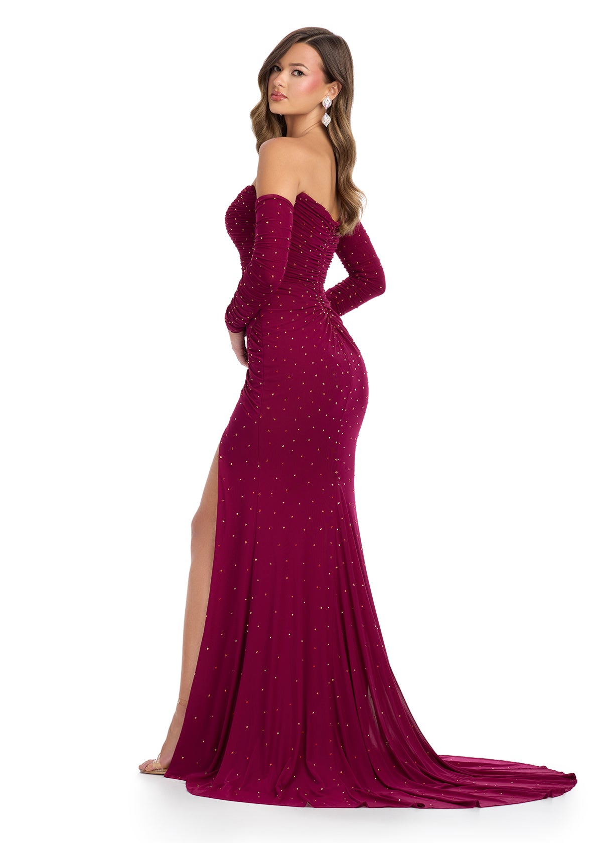 Back - Dazzling strapless gown featuring shimmering press-on stone embellishments, detachable sleeves for added elegance, a left leg slit, and a sweep train for a glamorous finish. Perfect for special occasions.