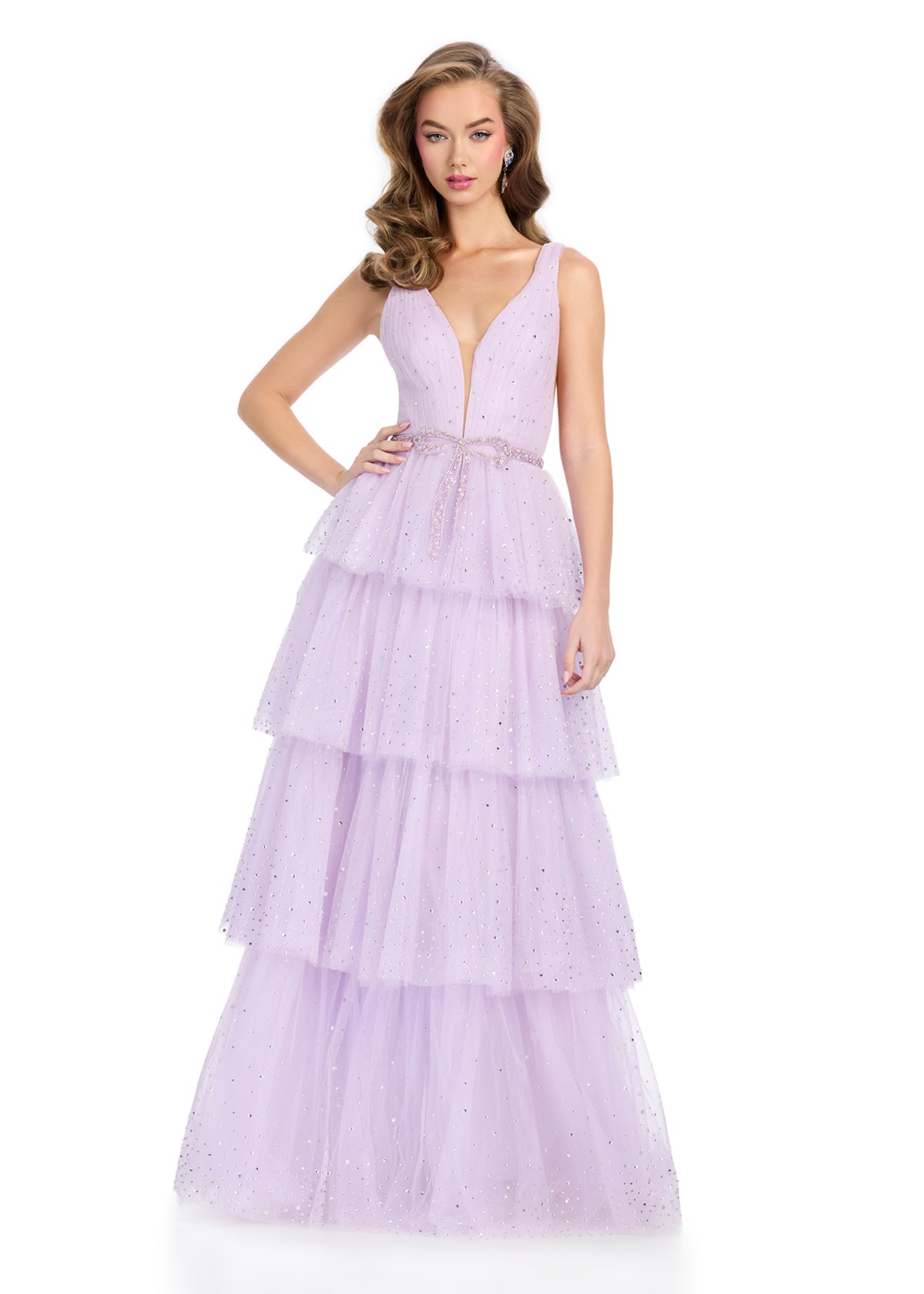 Sparkling fully stoned gown featuring a V-neckline, a tiered A-line skirt, and a crystal bow belt adorned with press-on stones for a glamorous and elegant look. Perfect for dazzling all night long.