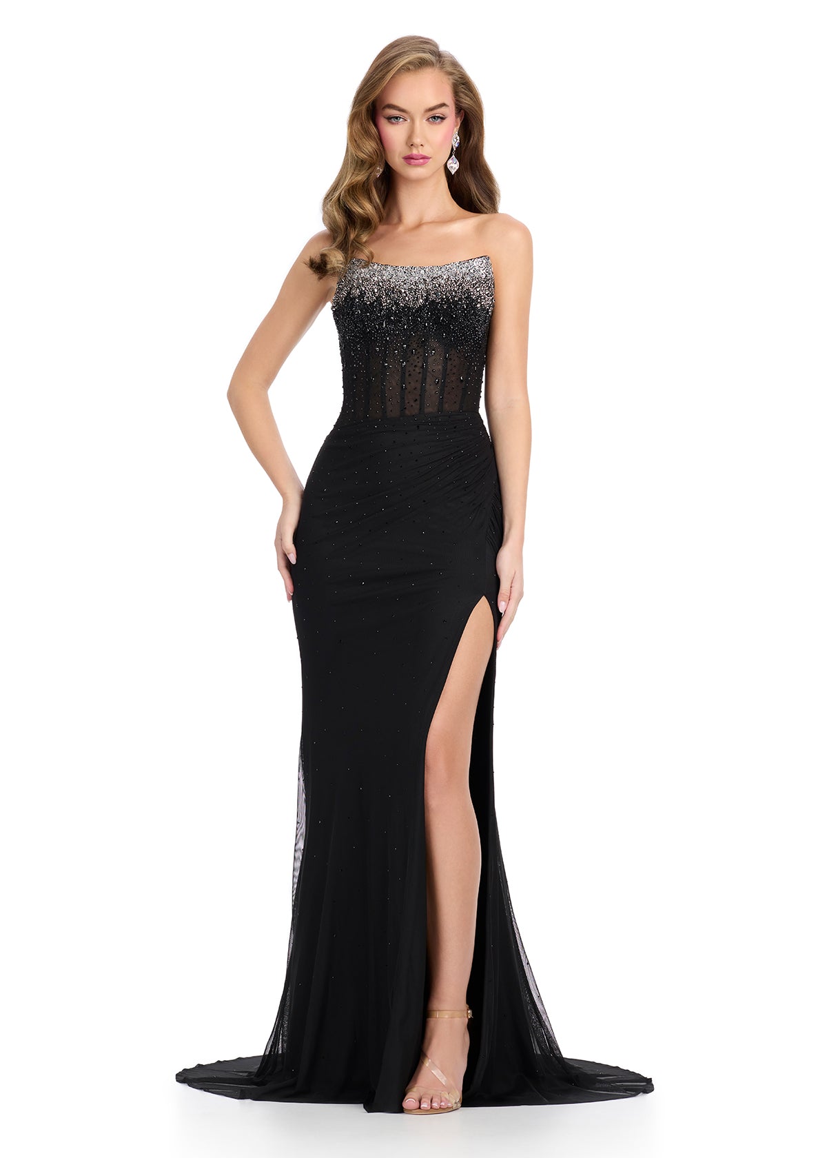 Breathtaking strapless gown featuring a beaded corset bustier, a press-on stone embellished skirt, a left leg slit, and a sweep train for an elegant and glamorous finish. Perfect for special occasions.