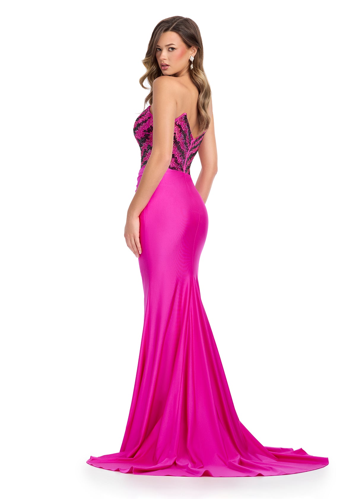 Back -  Sparkling strapless gown featuring a structured bustier adorned with press-on stones in an animal print-inspired pattern. Complete with a wrap skirt, right leg slit, and sweep train for a fierce and glamorous look. Perfect for special occasions.