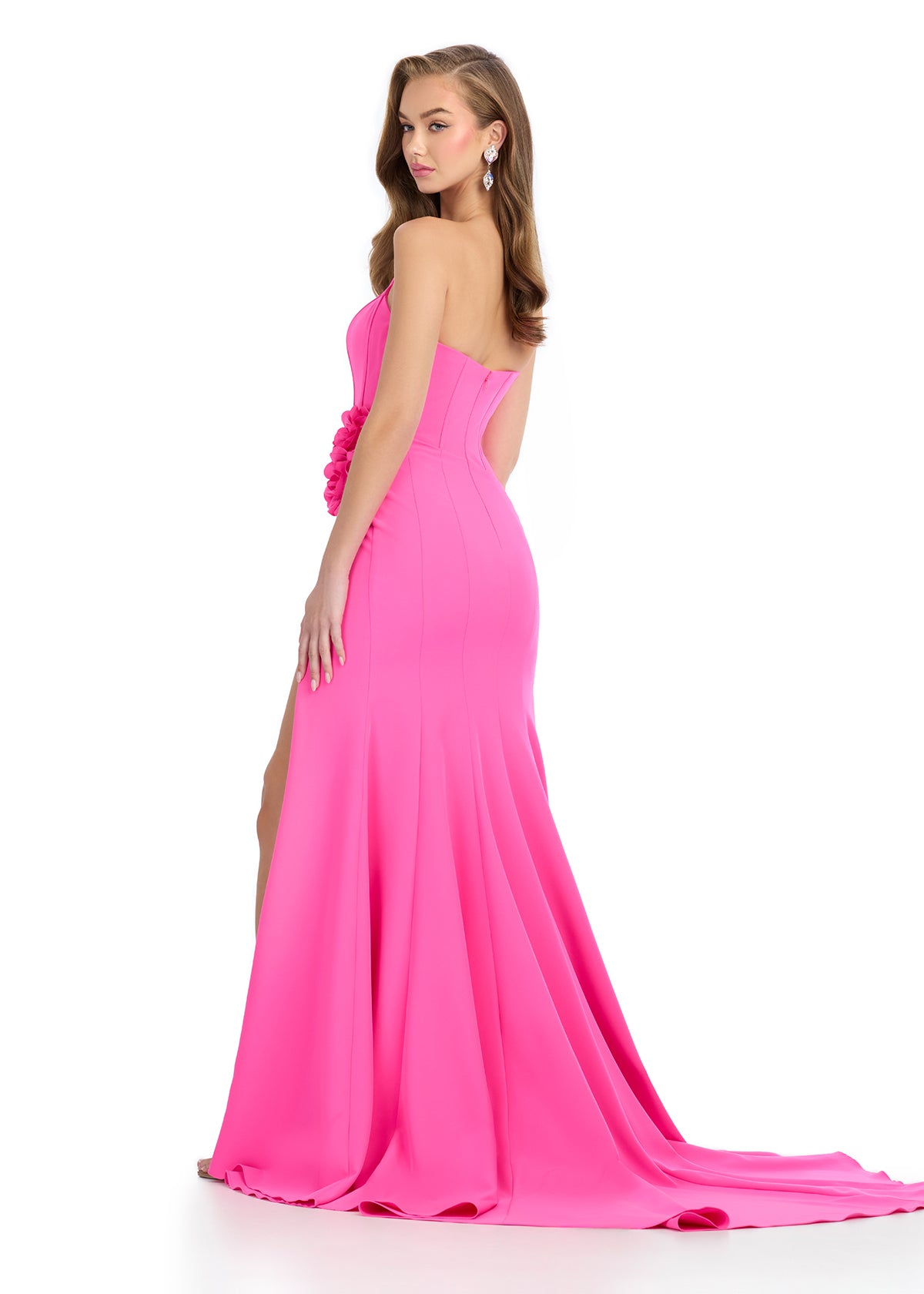 Back - Elegant jersey gown featuring a structured strapless corset bustier with boning, a ruched skirt, 3D floral accents along the hip, a left leg slit, and a sweep train for a glamorous finish. Perfect for special occasions.