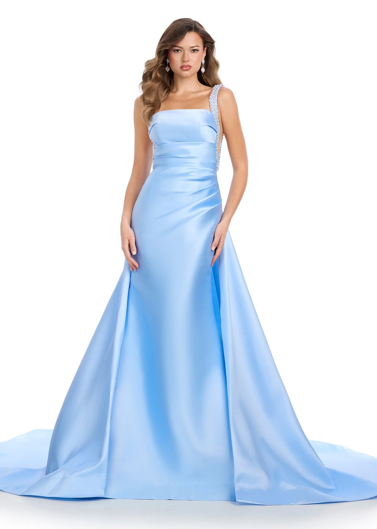 Regal mikado gown featuring fully beaded straps, a ruched bustier for a flattering fit, a sleek column skirt, and a sweeping overskirt for a dramatic, timeless look. Perfect for making a grand entrance.