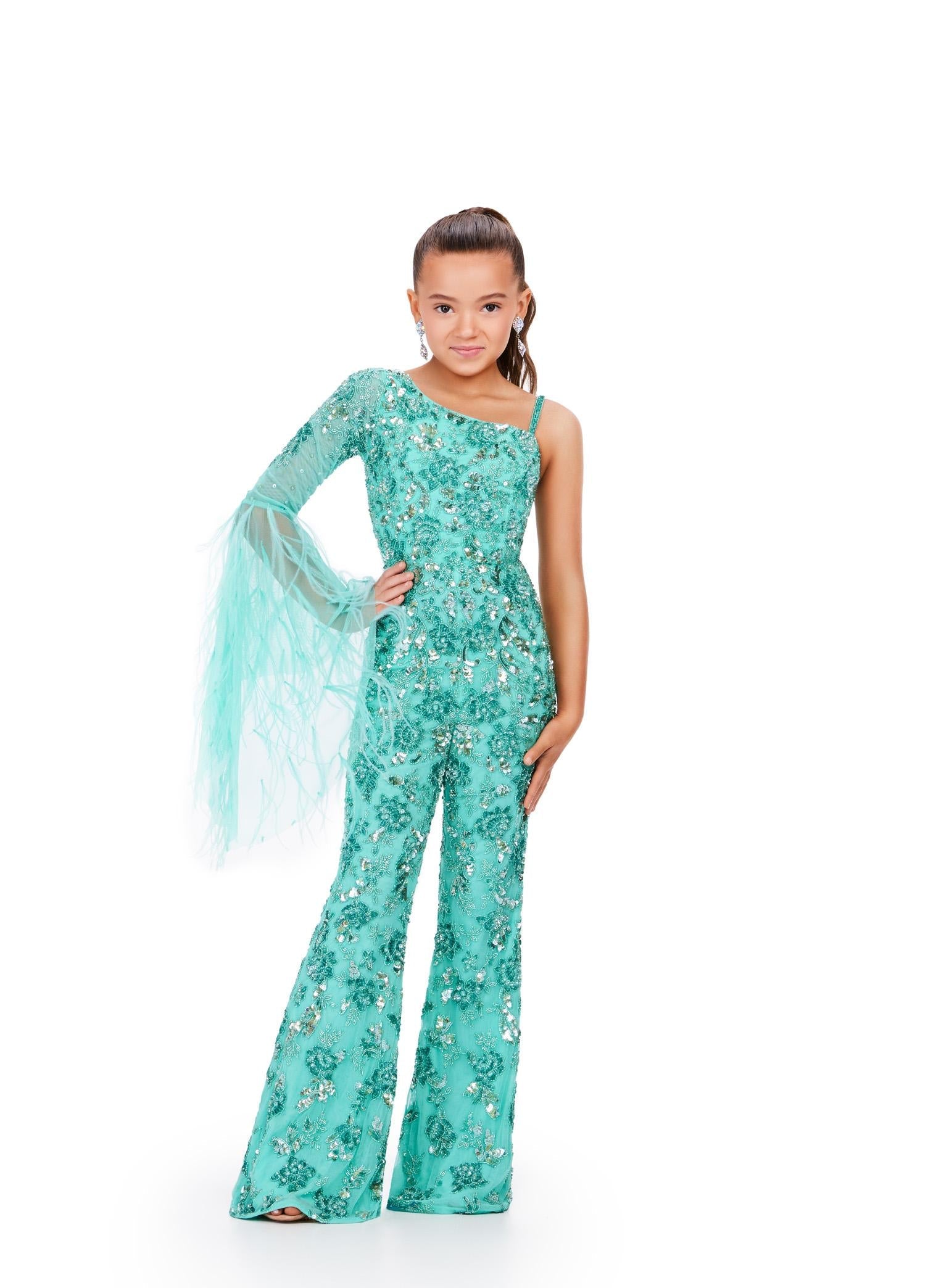 Aqua ASHLEYlauren 8268 one shoulder kids jumpsuit featuring an intricate bead pattern, a dramatic bell sleeve adorned with scattered feathers, and a sleek fitted silhouette for a bold and stylish look.