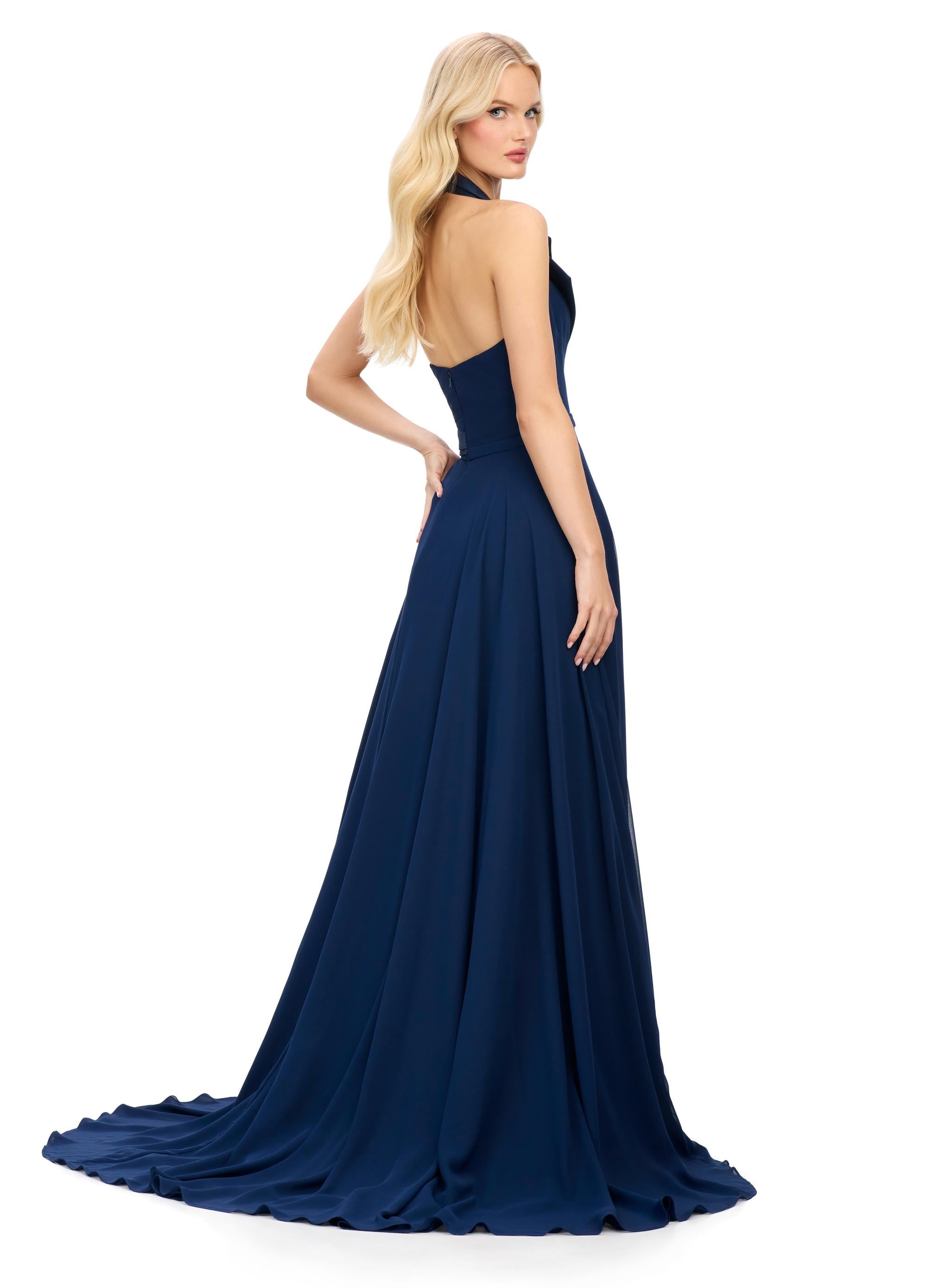 Back view. Navy ASHLEYlauren 11753 chiffon gown with structured halter neckline, A-line skirt, and elegant right leg slit — the perfect blend of edge and grace.