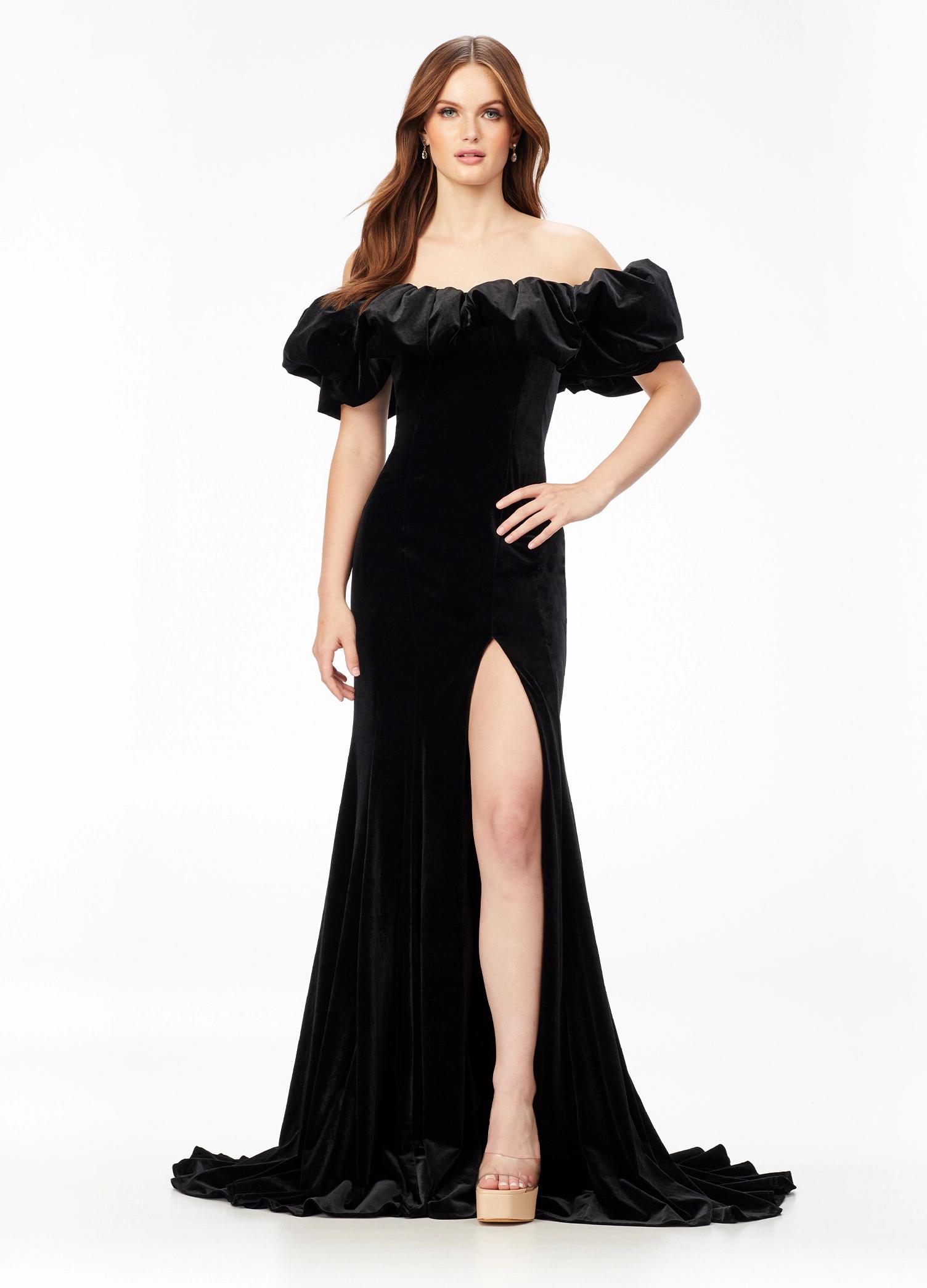 Black ASHLEYlauren 11217 – A magnificent off-shoulder velvet gown featuring oversized ruffle details, a contour seamed skirt with a left leg slit, and a dramatic train. Perfect for making a bold, elegant statement at any event.