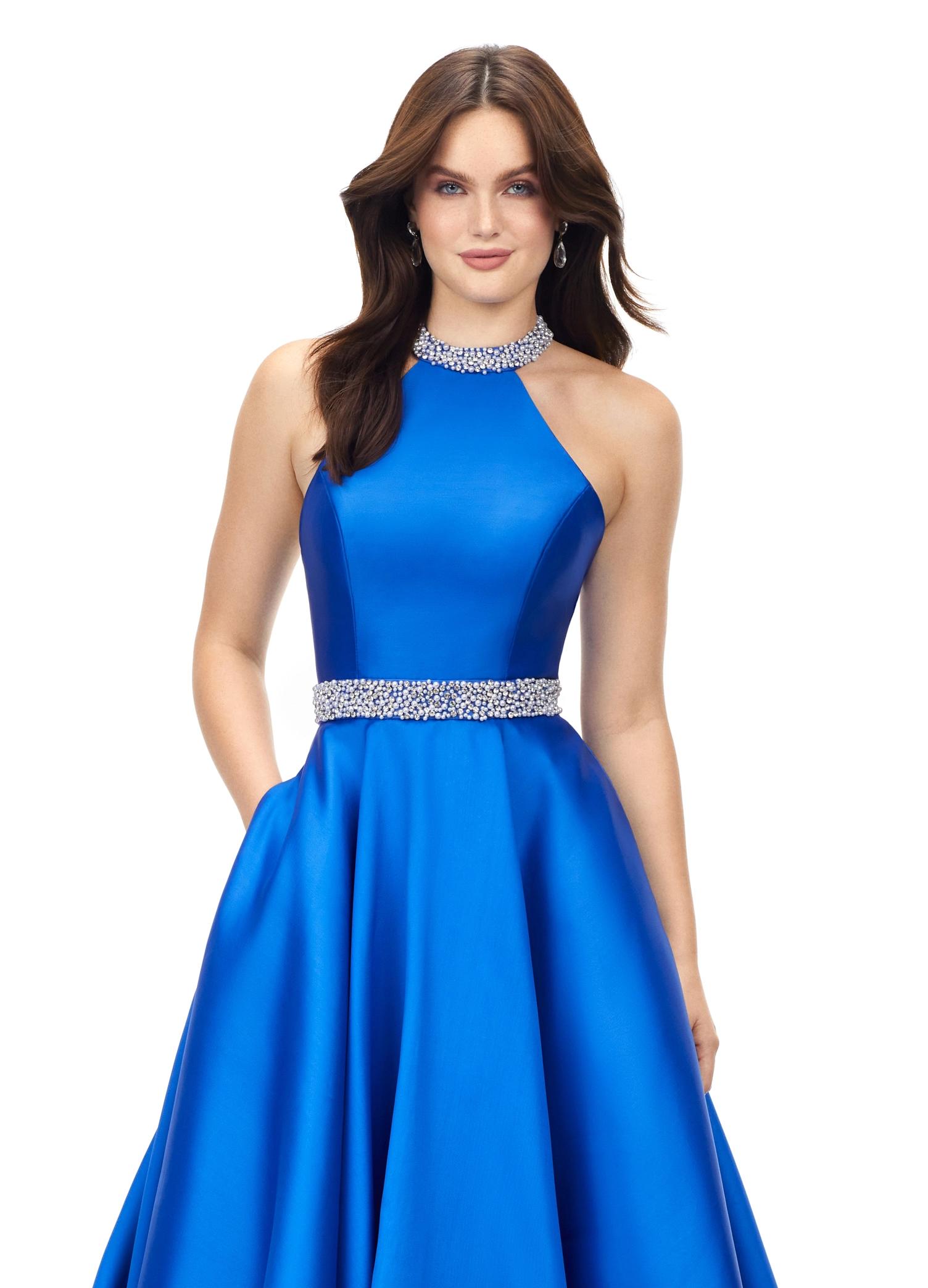 Blue ASHLEYlauren 11230 – A stunning A-line mikado gown featuring a crystal and pearl encrusted halter bustier and waistline, paired with a full ball gown skirt. Perfect for making an elegant statement at your next event.