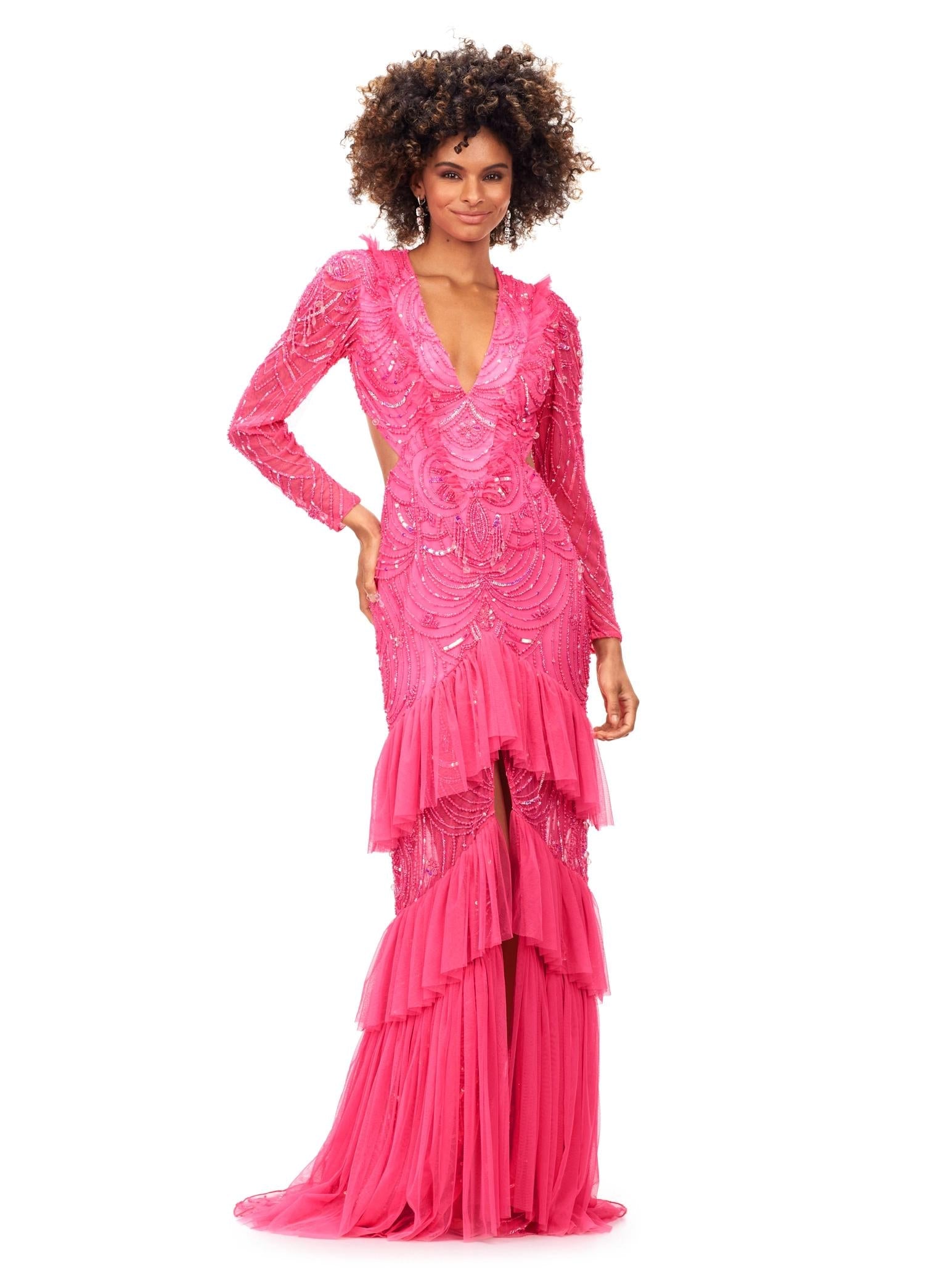 Pink ASHLEYlauren 11199 – A dramatic v-neck beaded gown featuring long sleeves, ruffle accents, a center slit, and a sweep train. Perfect for making a bold and elegant statement at any special event.



