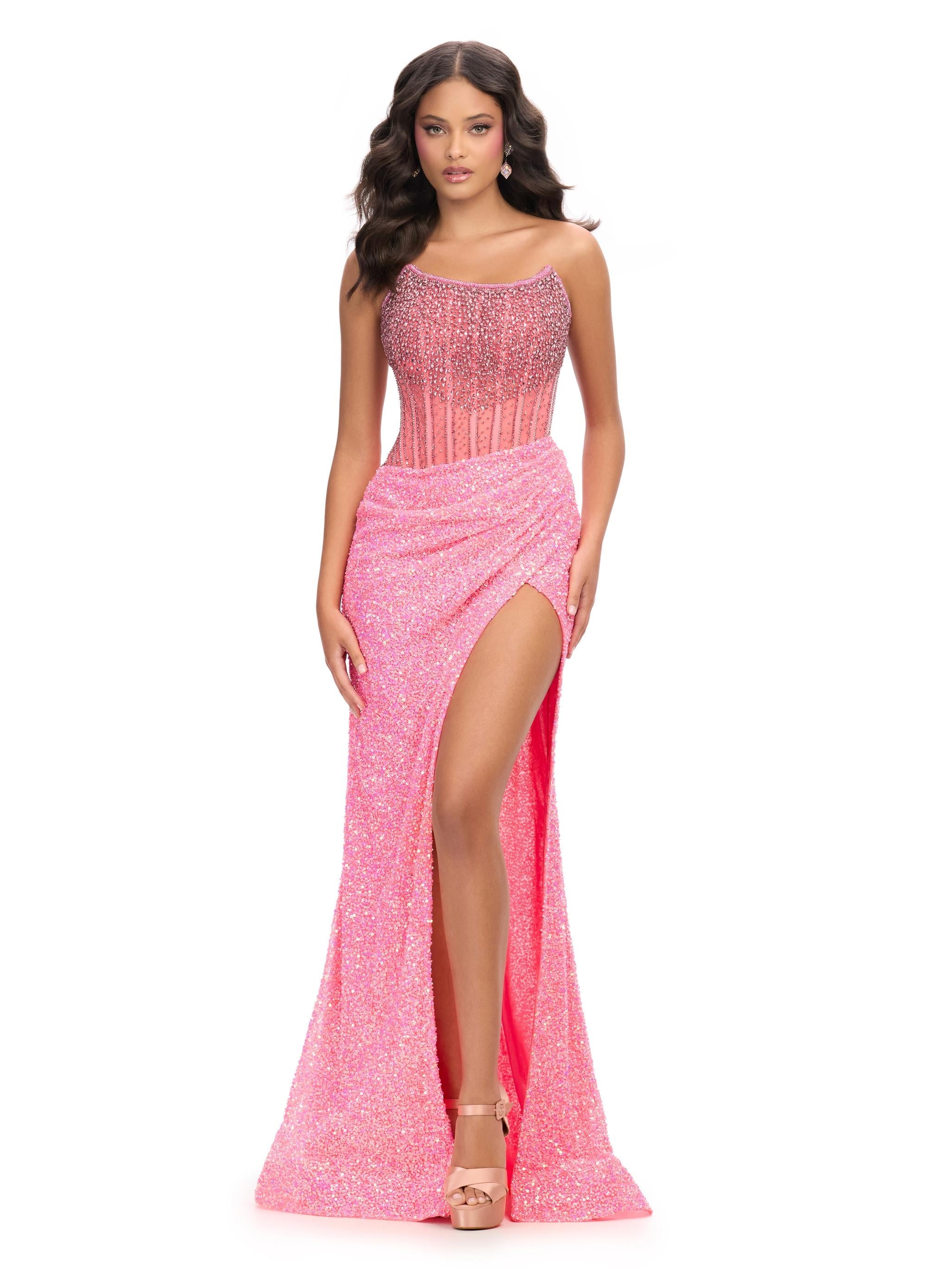 Pink ASHLEYlauren 11236 jaw-dropping strapless gown featuring a fitted silhouette, corset bustier with stunning crystal beadwork, a fully beaded wrap skirt, and a left leg slit for a glamorous red carpet-worthy look.