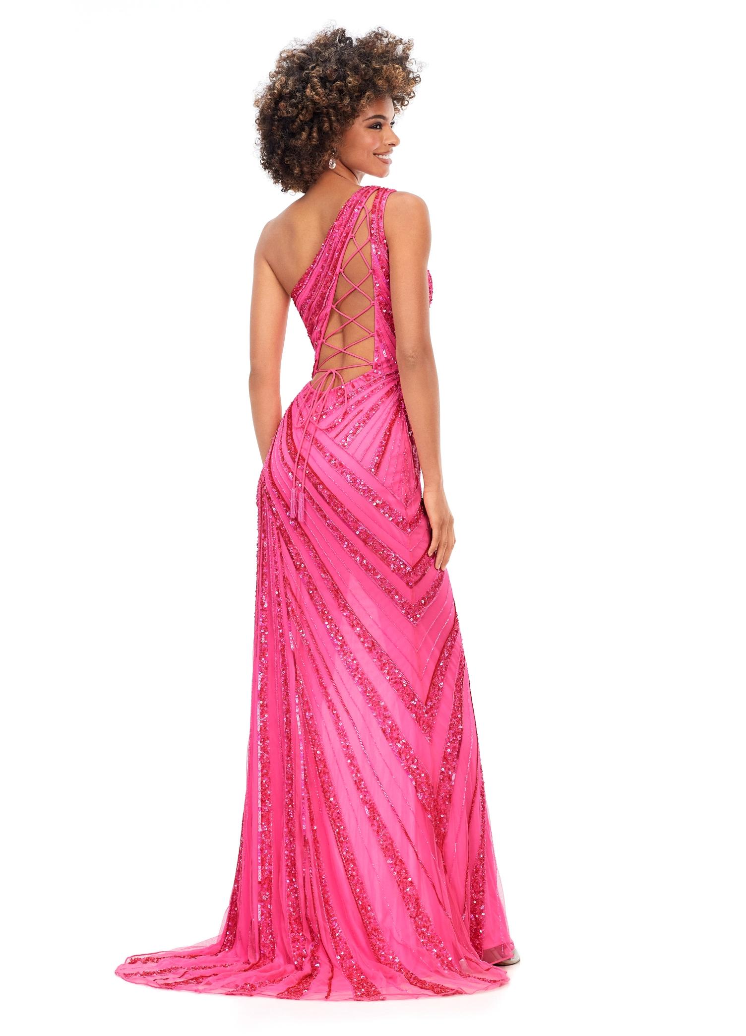 Pink ASHLEYlauren 11244 – A stunning one-shoulder gown featuring intricate beadwork that accentuates your curves, a left leg slit, and a signature asymmetrical lace-up back. Perfect for making a show-stopping statement at any event.