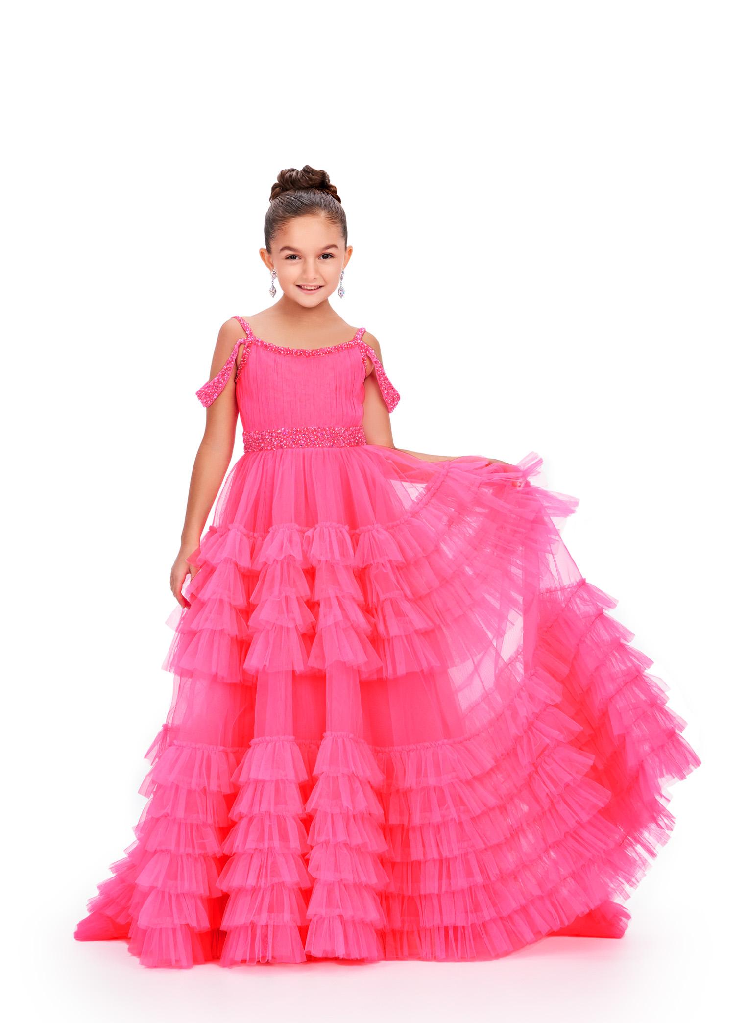 Pink ASHLEYlauren 8261 kids ball gown featuring a beaded scoop neckline, V-back, off-the-shoulder draping straps, and a dramatic tiered tulle skirt with a sweeping train for an enchanting and elegant look.