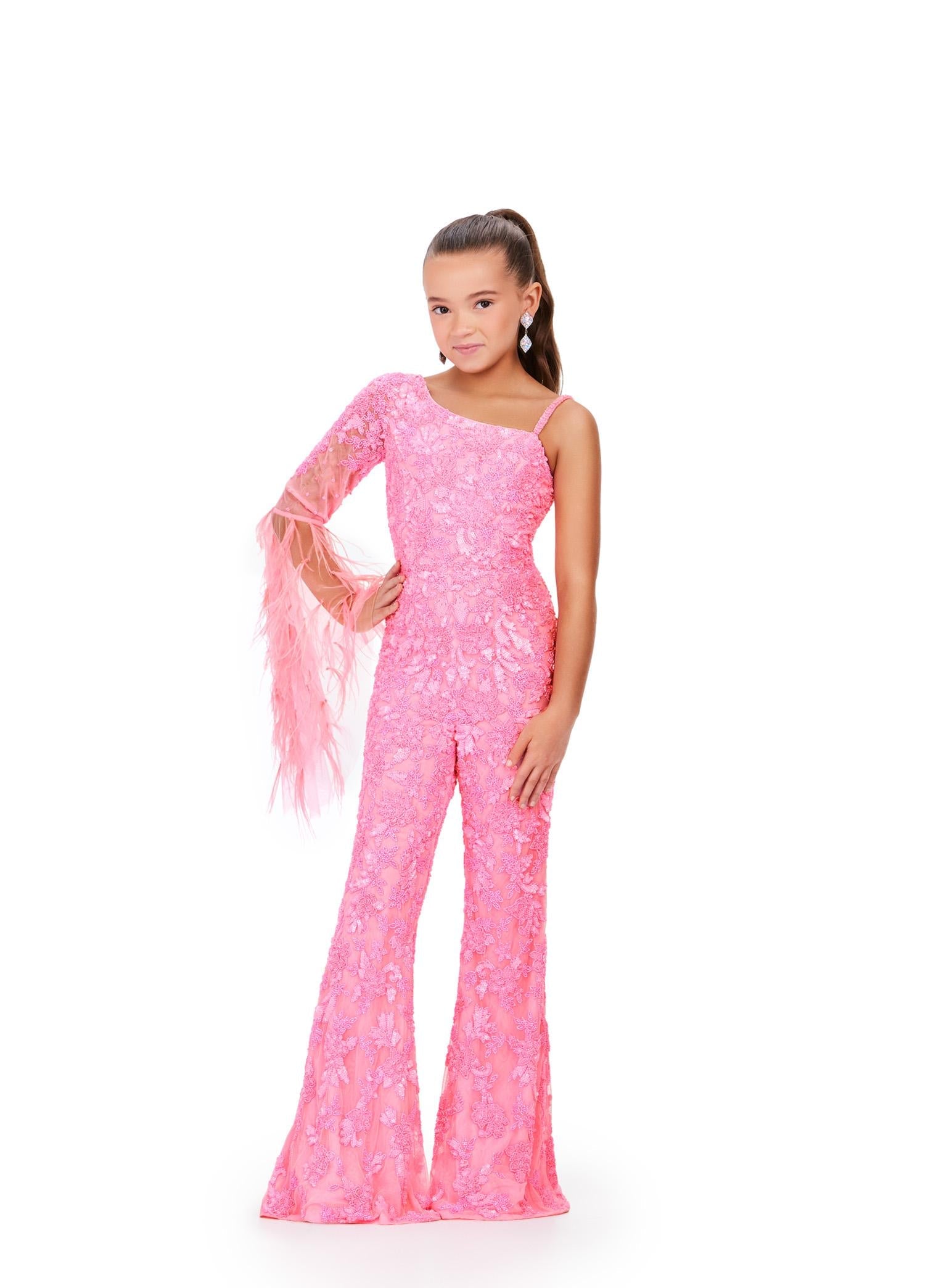 Pink ASHLEYlauren 8268 one shoulder kids jumpsuit featuring an intricate bead pattern, a dramatic bell sleeve adorned with scattered feathers, and a sleek fitted silhouette for a bold and stylish look.