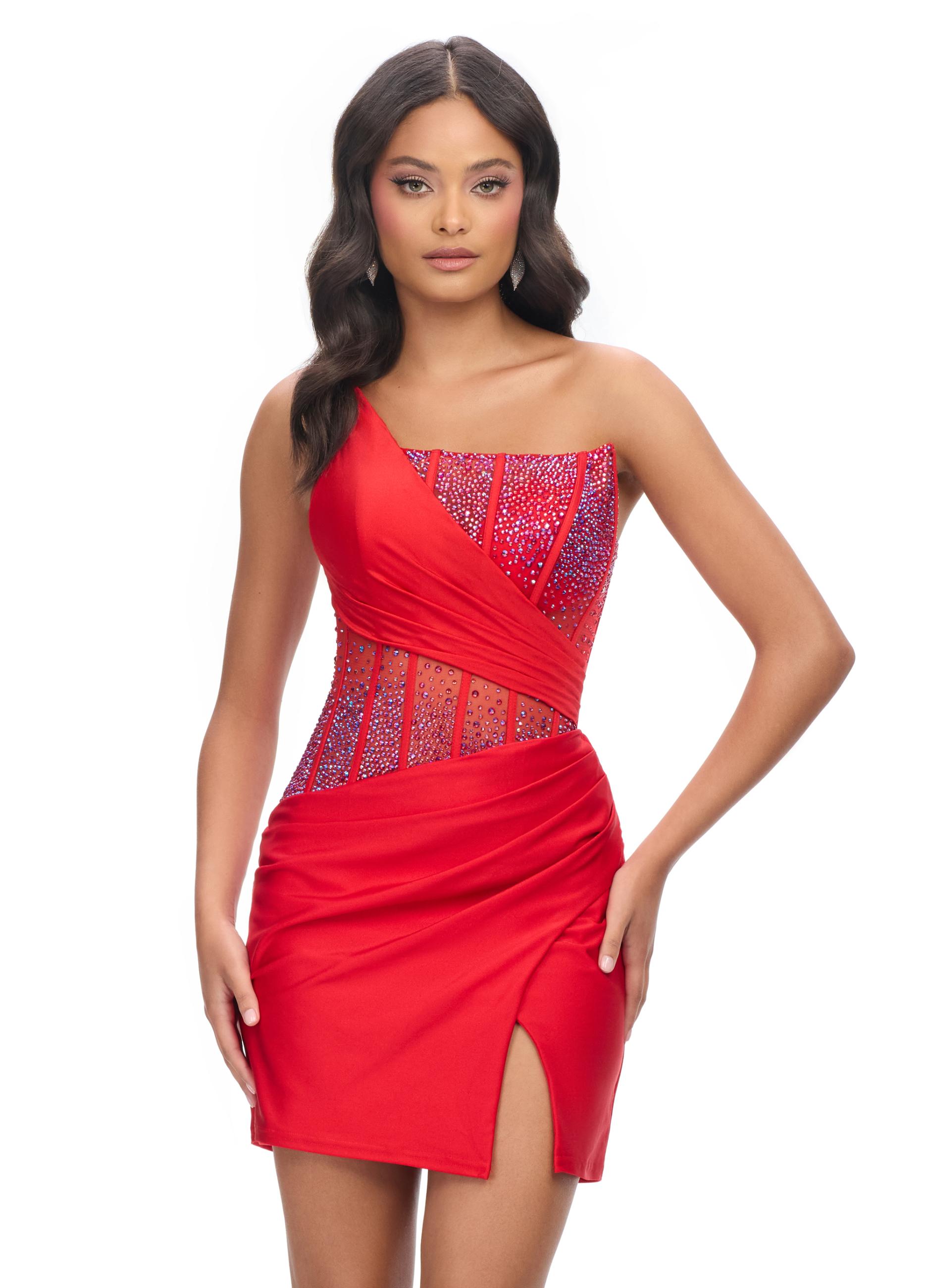 Red ASHLEYlauren 4691 one shoulder cocktail dress featuring a fully beaded corset bustier with press-on stones, a wrap skirt, and a left leg slit for an elegant and glamorous look.