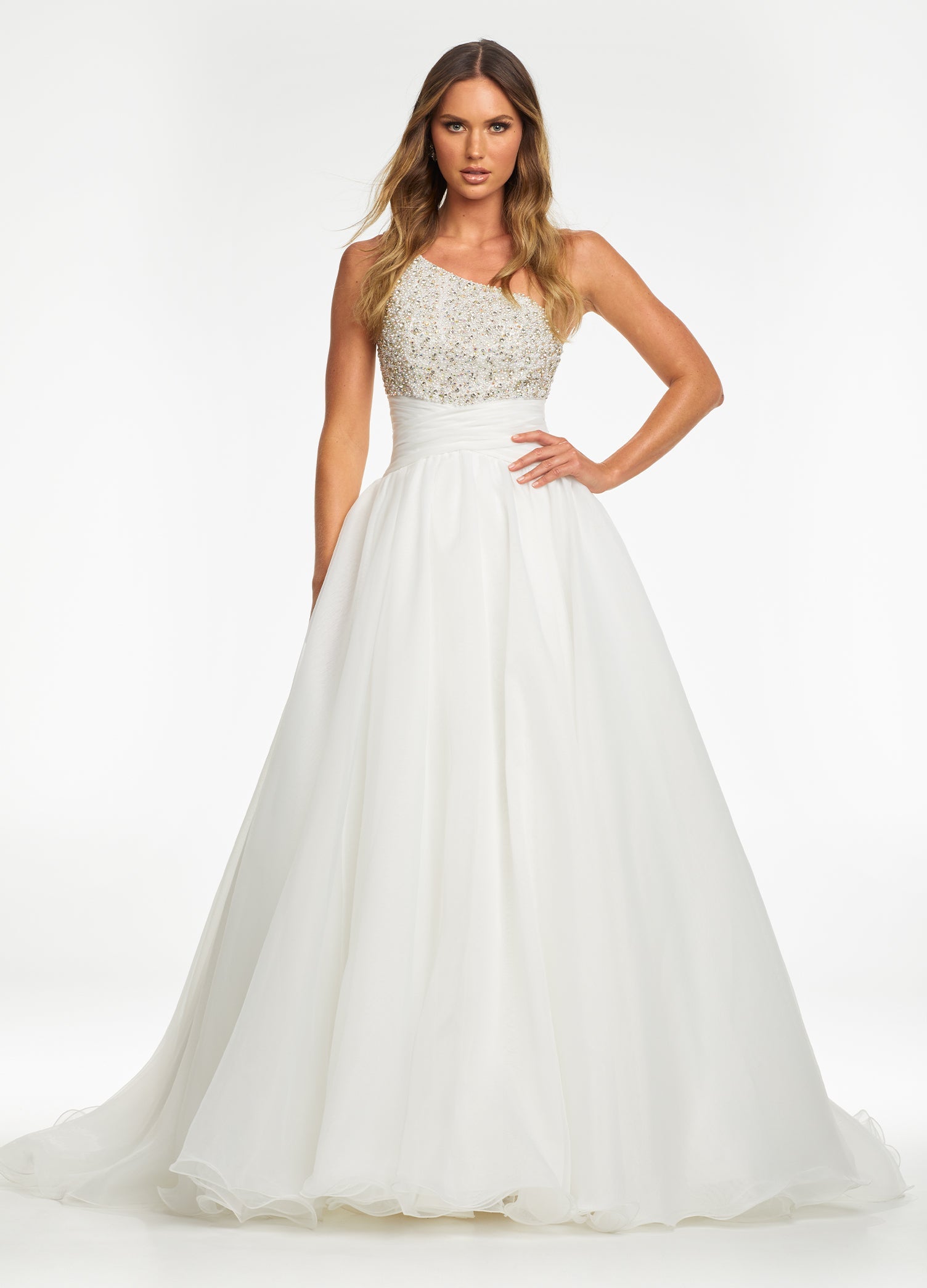 white ASHLEYlauren 11127 – An elegant one-shoulder organza ball gown featuring an encrusted crystal and pearl detail bustier, a ruched wrap waist for a flattering silhouette, and a full ball gown skirt. Perfect for any formal event.