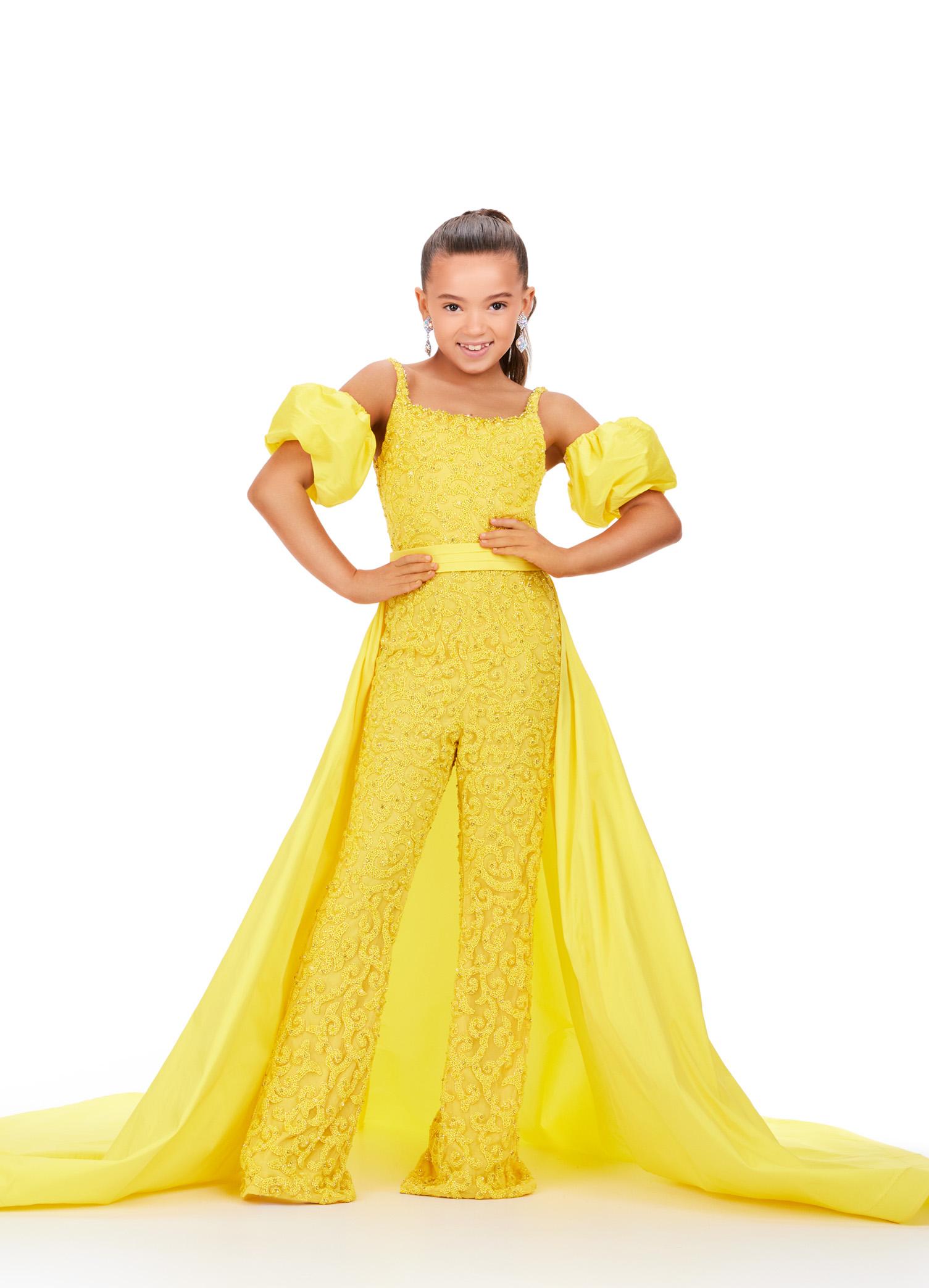 Yellow ASHLEYlauren 8269 fully beaded kids jumpsuit featuring a square neckline, dramatic removable taffeta puff sleeves, and a detachable taffeta overskirt for a bold and versatile statement look.