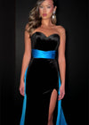 Video - Classic and elegant strapless velvet gown featuring a figure-flattering satin overskirt that cinches the waist, paired with a left leg slit for a sophisticated and timeless look. Perfect for special occasions.