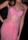 Video -  Showstopping beaded gown featuring a structured corset bustier with exposed boning, a sweetheart neckline, and delicate spaghetti straps. The cut-out back and cascading press-on stones add a touch of elegance, while ruffle details and a center slit complete the glamorous look. Perfect for making a grand entrance.