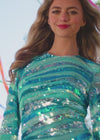 Video. Aqua ASHLEYlauren 4508 glamorous hand-beaded gown featuring a high crew neckline, long sleeves, contoured striping for a flattering silhouette, and an asymmetrical sequin skirt for an elegant finish.