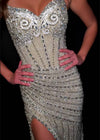 Video -  Elegant strapless gown featuring a sweetheart neckline, exposed corset boning, intricate beadwork, and a right leg slit. Finished with fringe detailing for a glamorous touch. Perfect for special occasions.